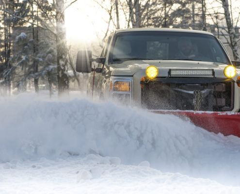 Snow plow doing snow removal after a blizzard